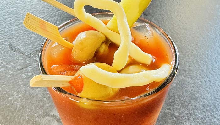 Bloody mary garnished with pickle, sting cheese and olives served at Heritage 71 restaurant and bar in Sherwood, WI Bloody mary garnished with pickle, sting cheese and olives served at Heritage 71 restaurant and bar in Sherwood, WI